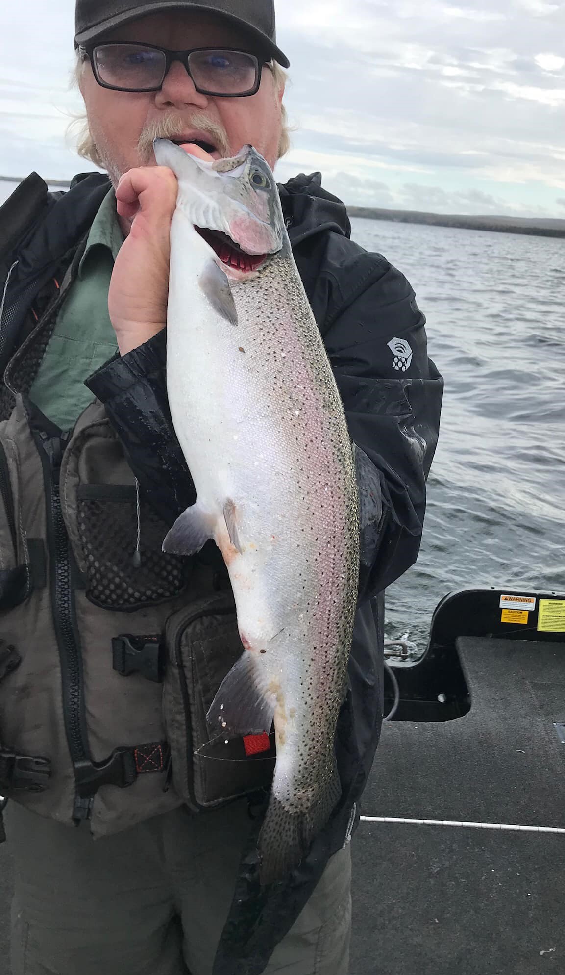 Jed holding Rainbow Trout while on the water