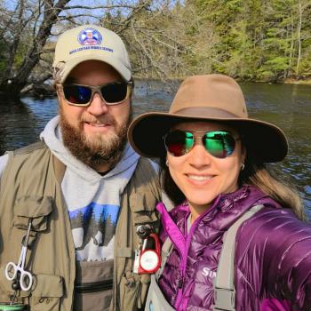 shan and sali standing in front of water wearing fishing gear